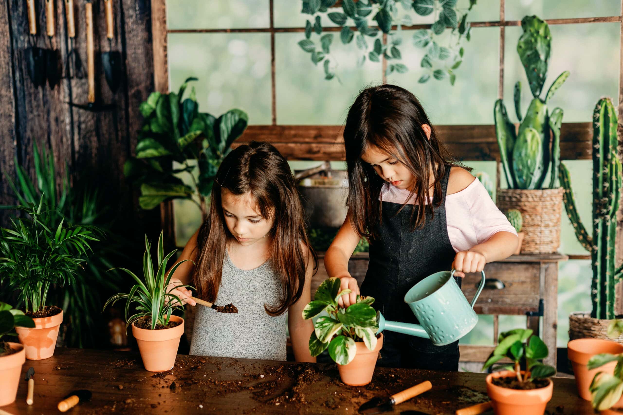 Spring Mini Sessions: Two young girls are transplanting houseplants